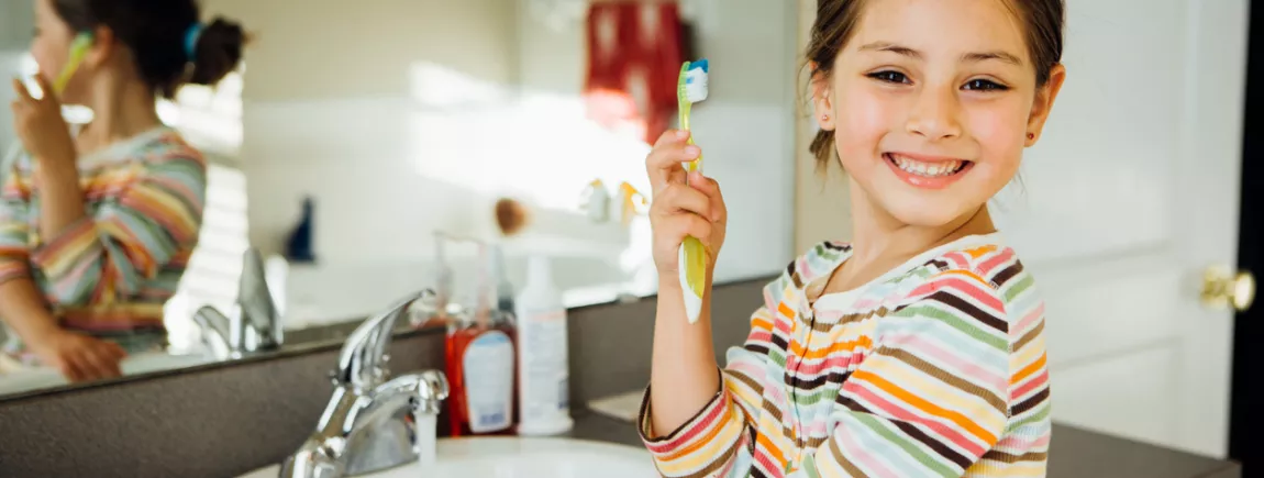 Fillette montrant sa brosse à dent